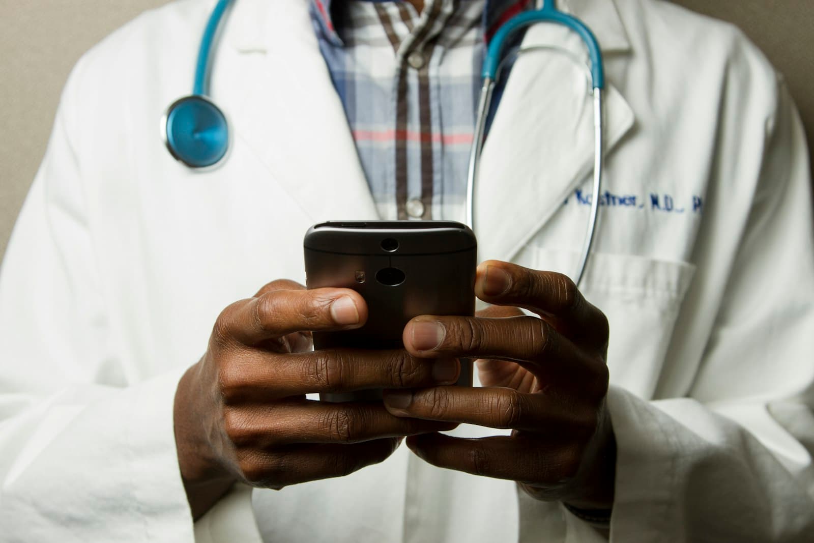 Healthcare professional reviewing information on a phone